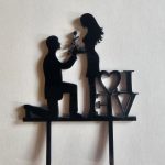 Boy gives girl rose topper